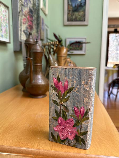 Painting of pink flowers on a wooden block