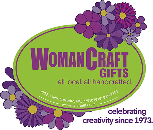 Woman Craft Gifts Logo - Purple sans-serif type inside green oval with purple flowers surrounding