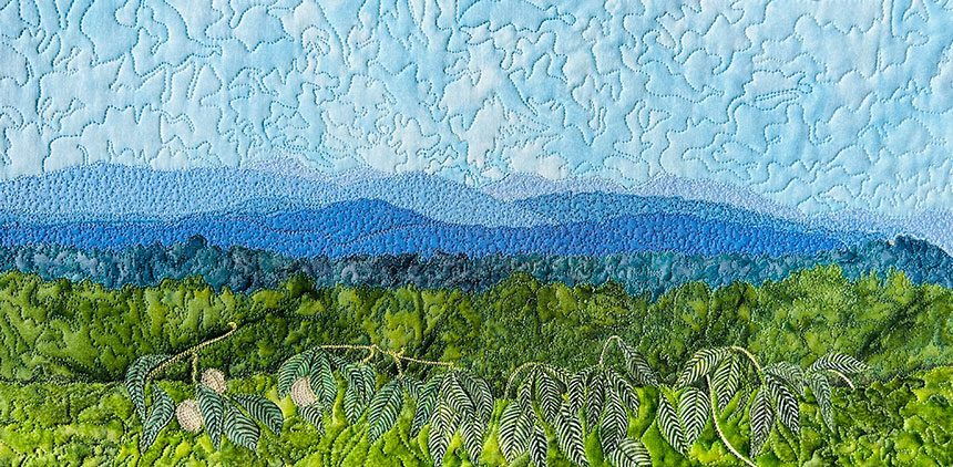 Art quilt featuring the Blue Ridge Mountains, in shades of green and blue.