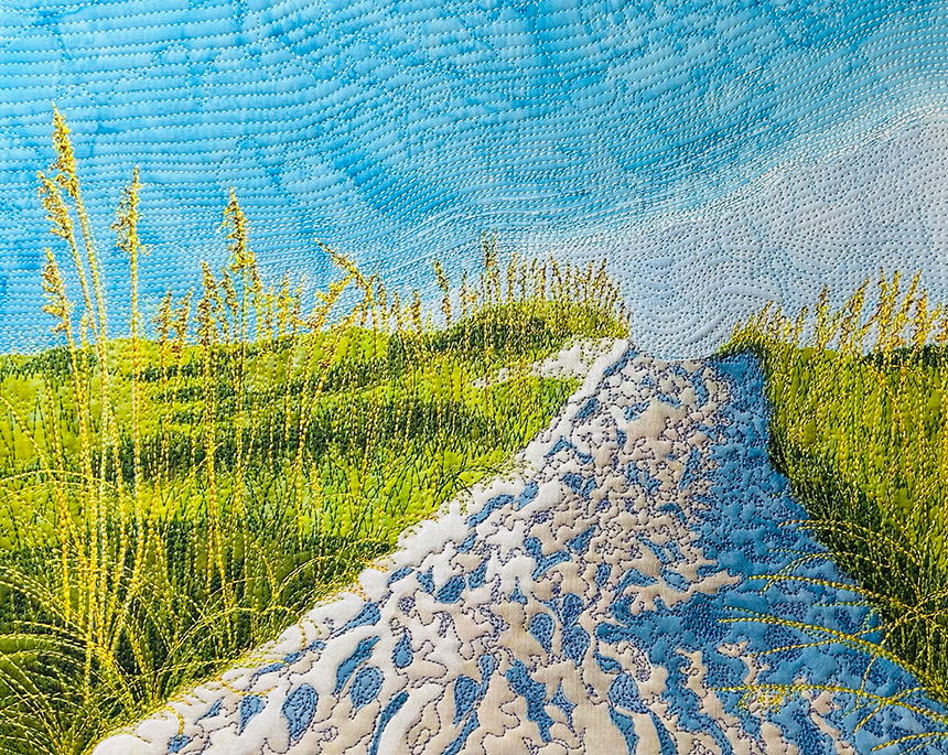 Art quilt by Susan Brubaker Knapp of a sandy path to the beach, with a blue sky and green sea oats.